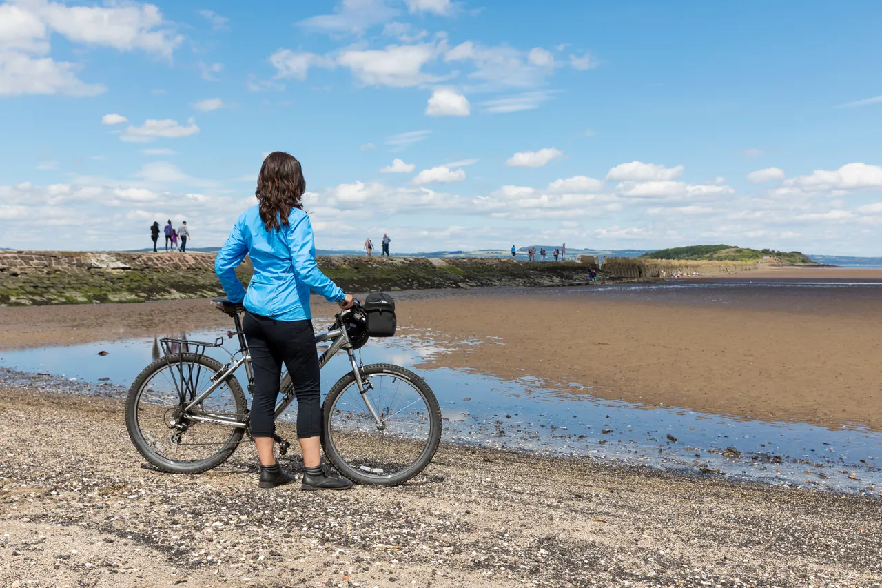 Cyclist on Cramond Beach