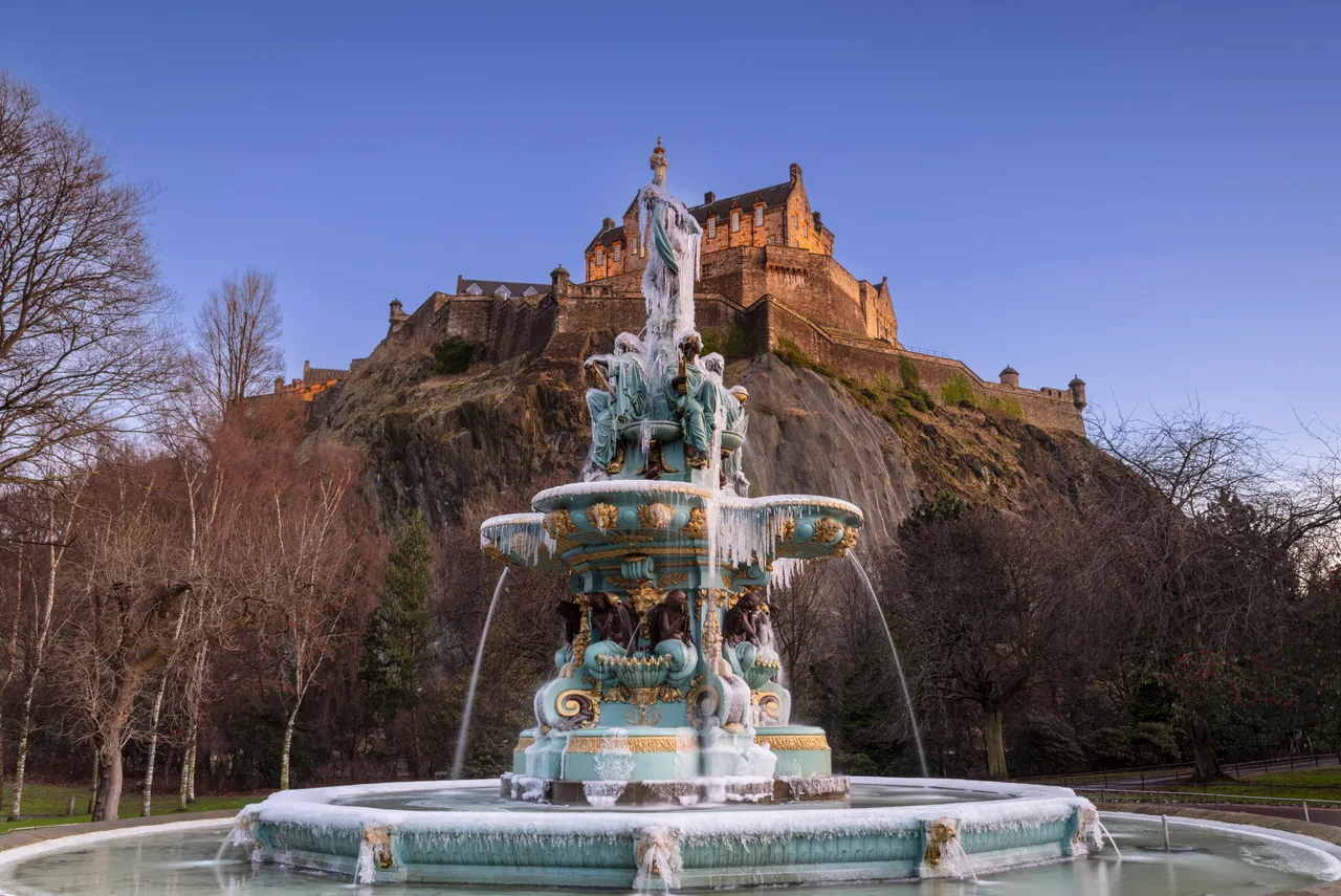 A frozen Ross Fountain with Edinburgh Castle from Princes Street Gardens