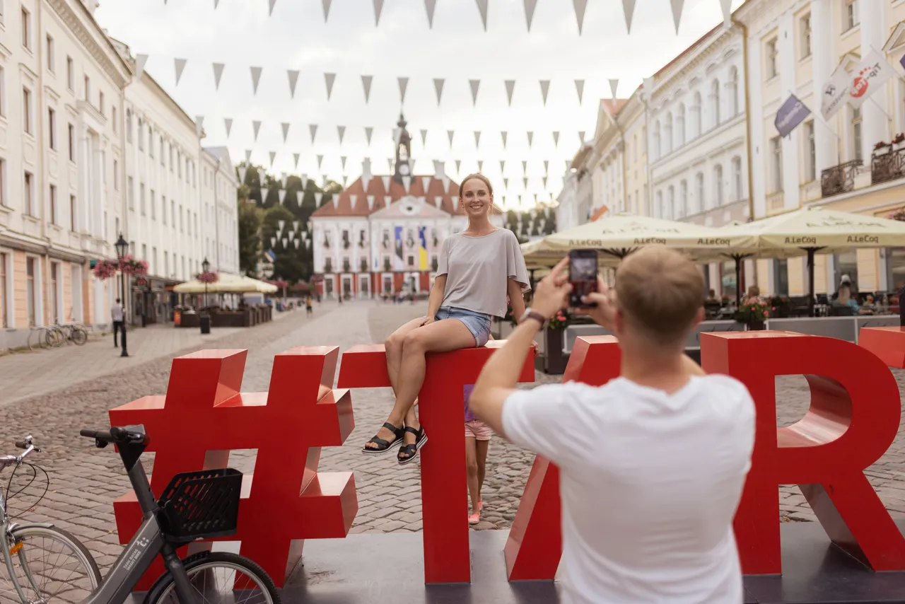Man photographing woman