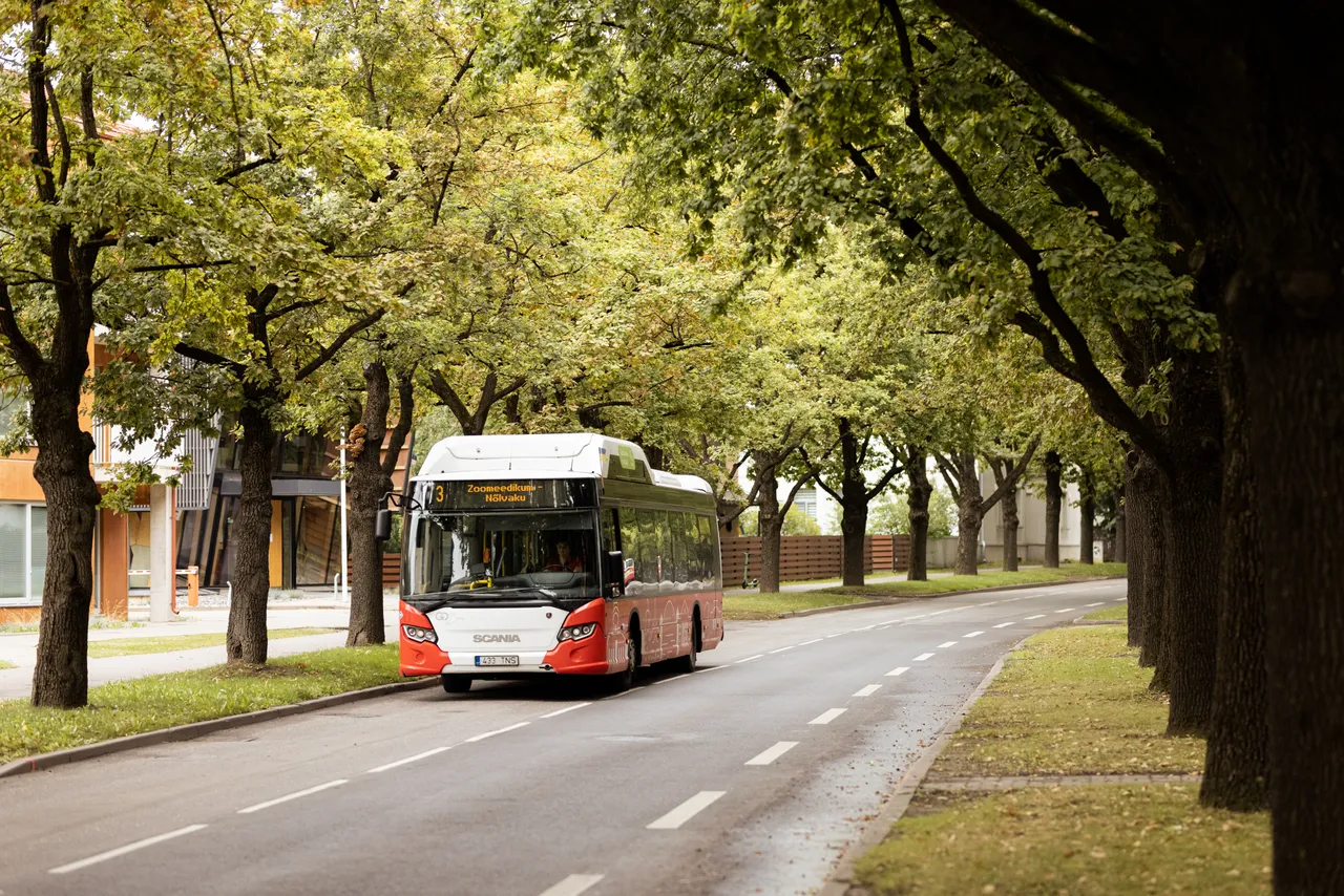 Biogas bus driving on city street