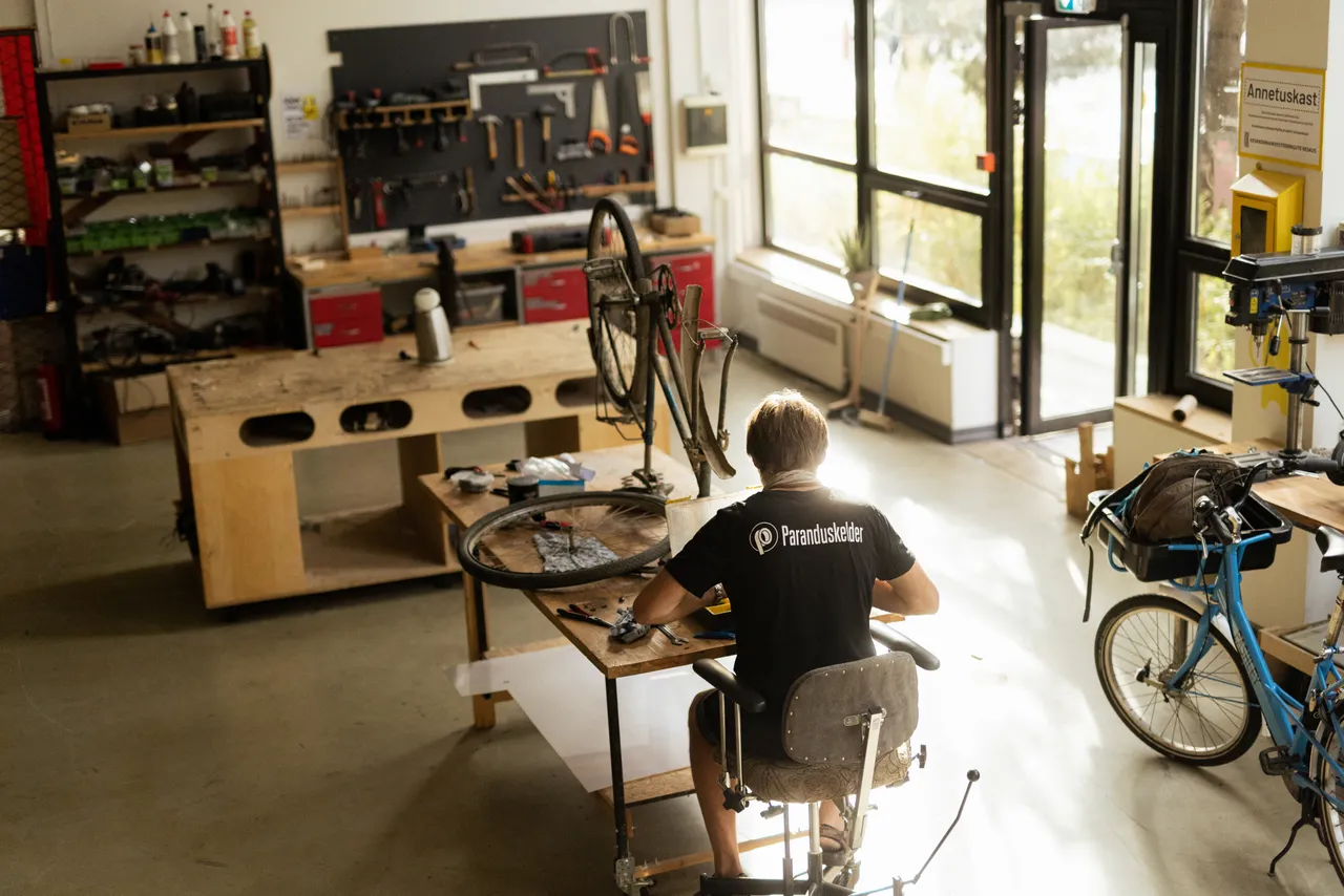 Man repairing bicycle in workshop