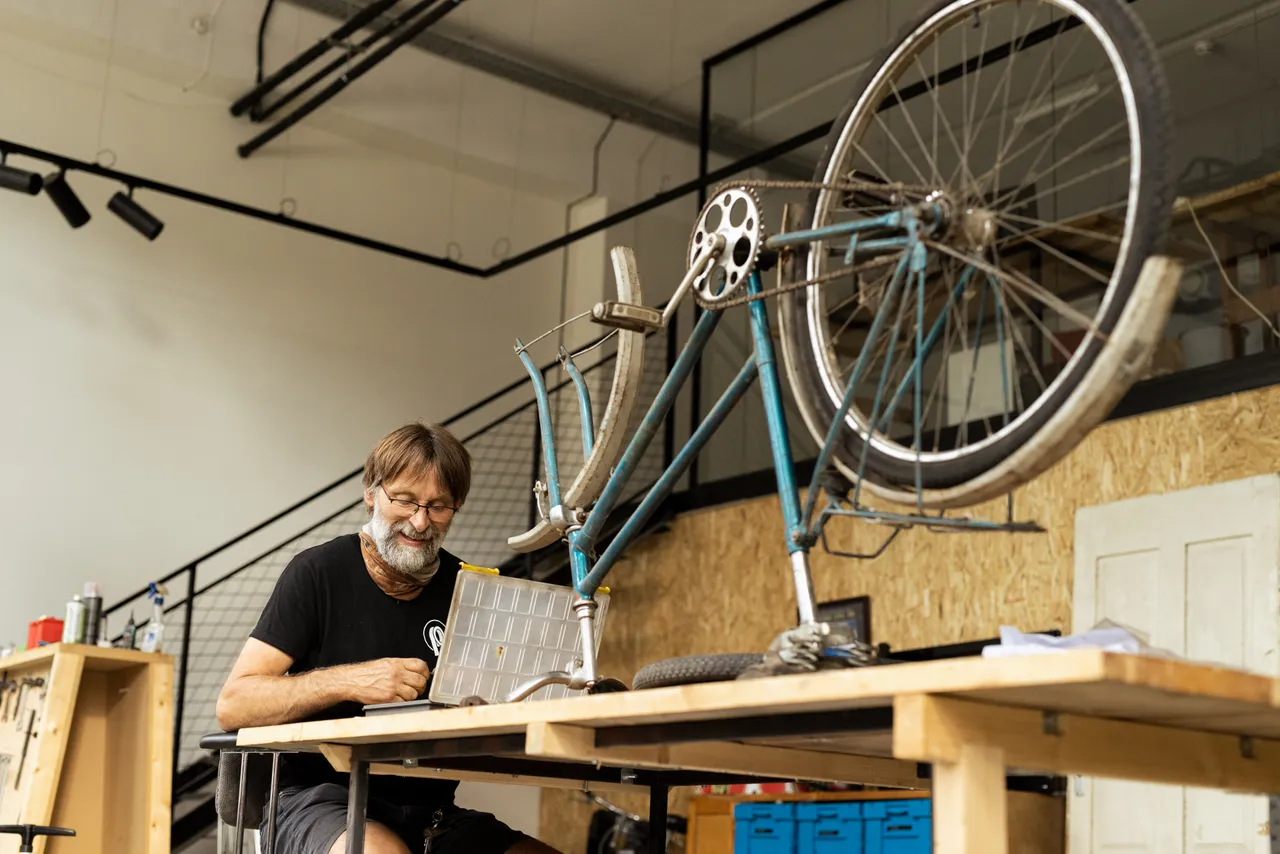 Man repairing bicycle in workshop