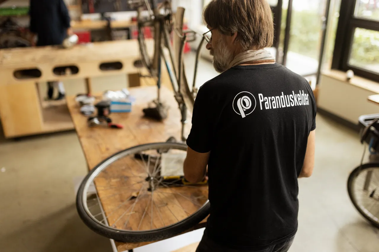 Man repairing bicycle in workshop