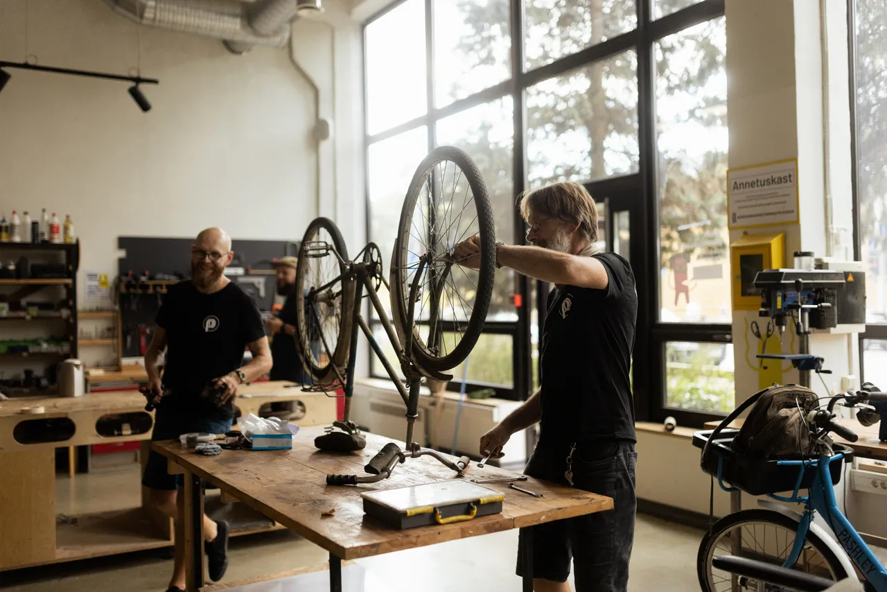 Man repairing bicycle in workshop