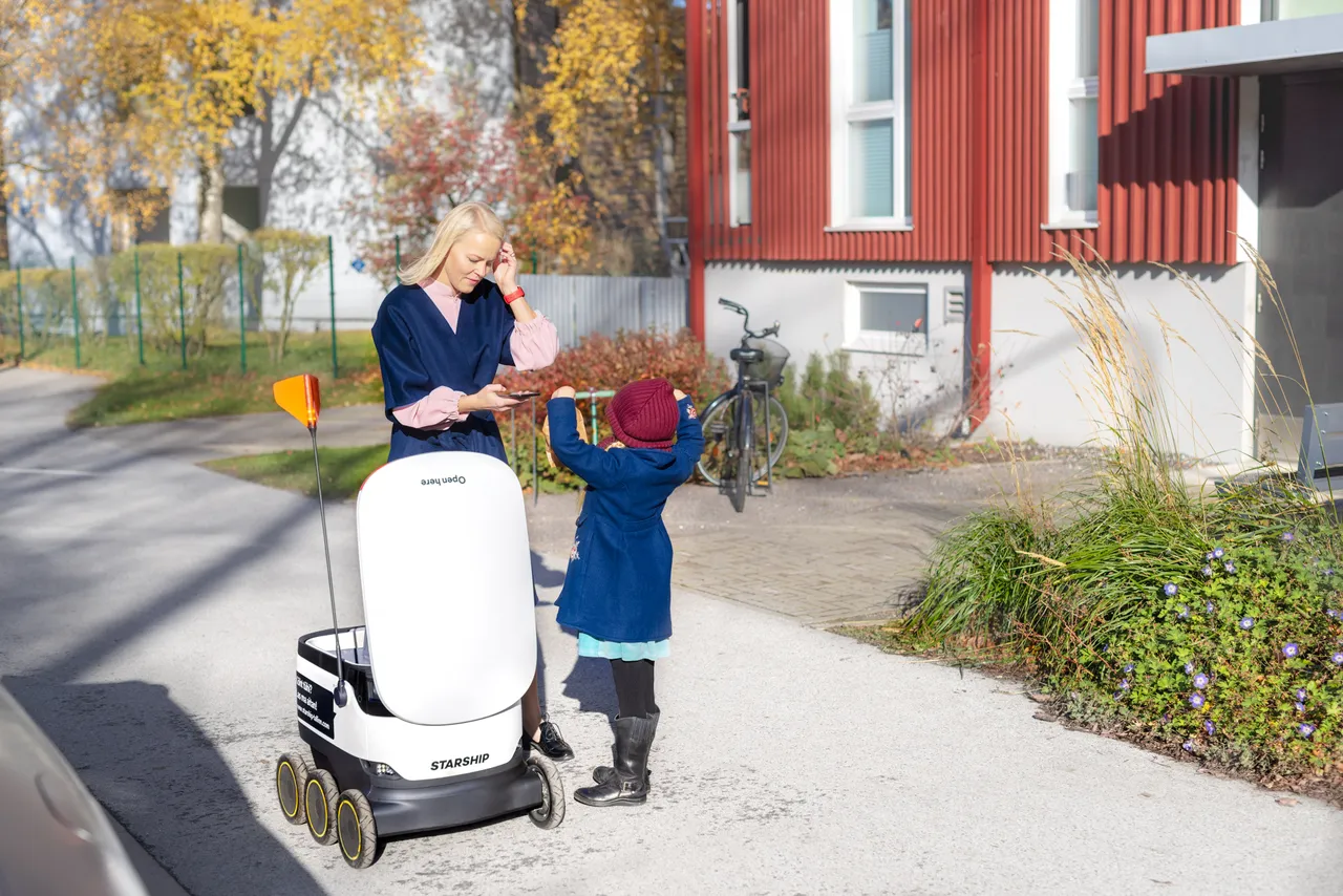 Woman, baby and a Starship robot
