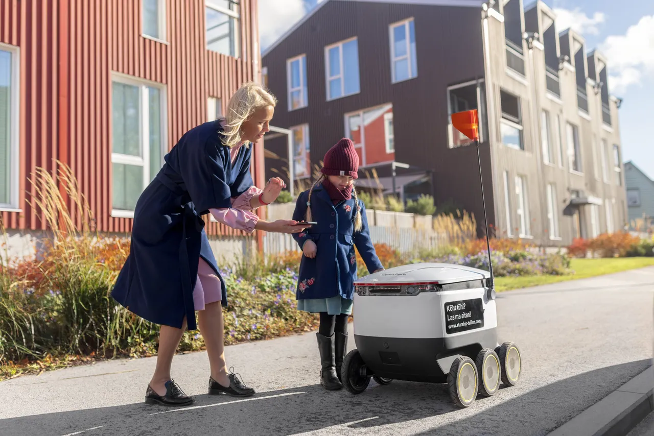 Woman and child receiving delivery robot order