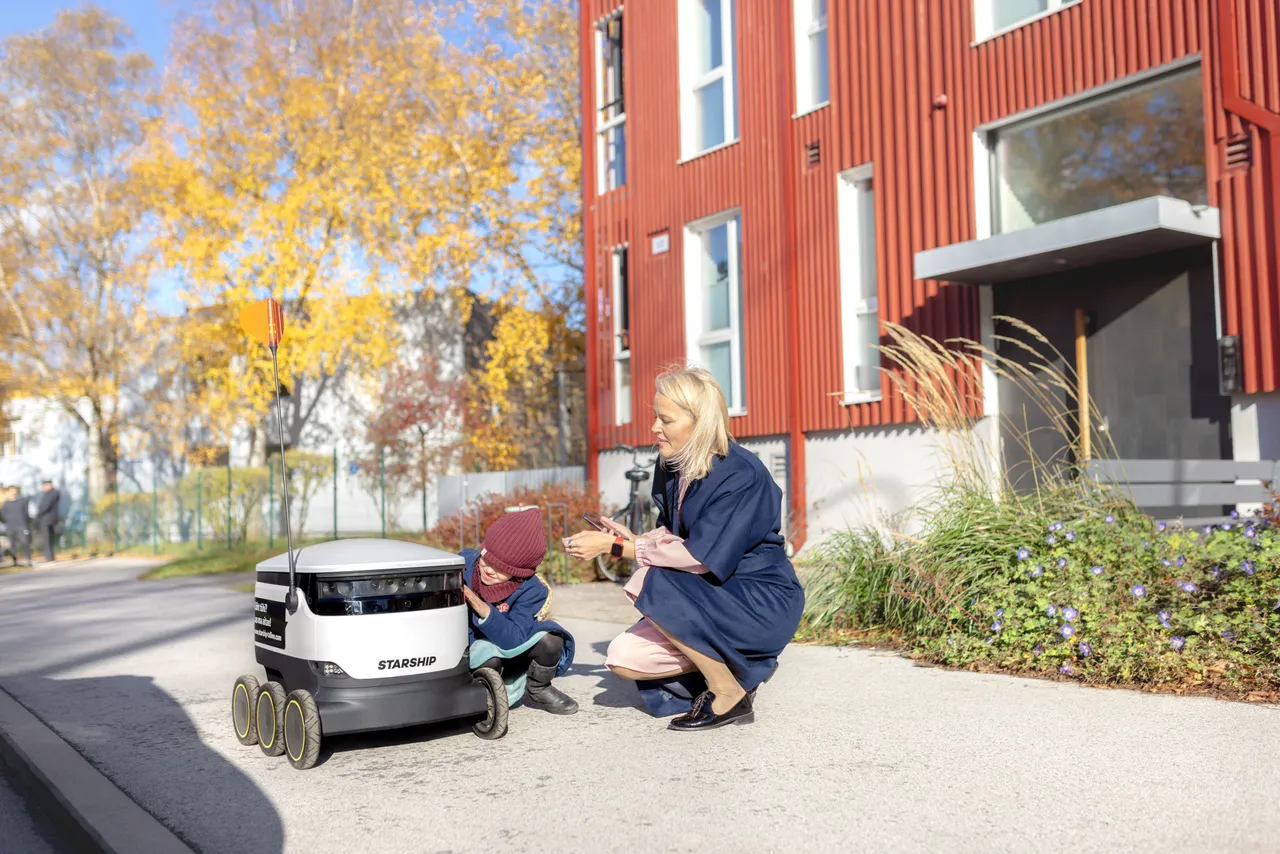 Woman and child receiving delivery robot order