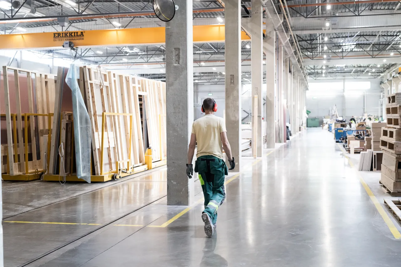 Man in wooden modula house factory