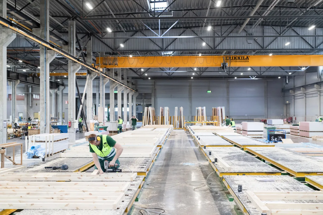 Man assembling wooden modular houses