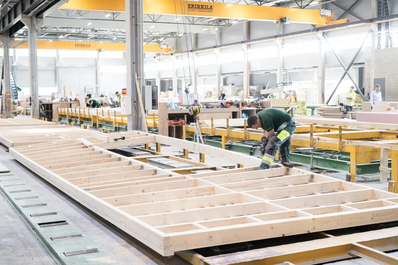 Man building wooden modular house elements