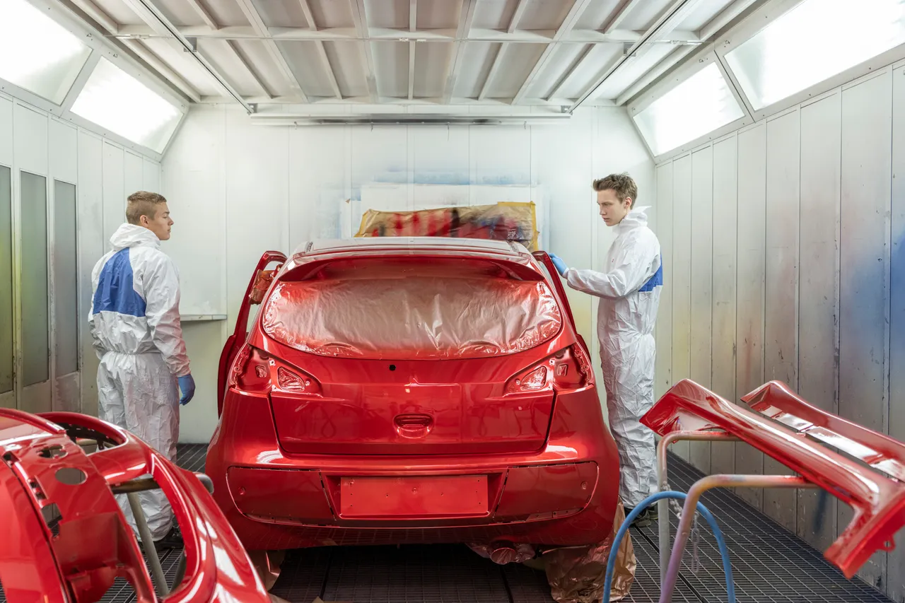 Men spray painting car