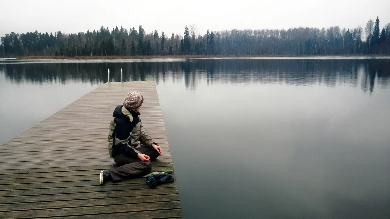 Woman Sitting by a Lake