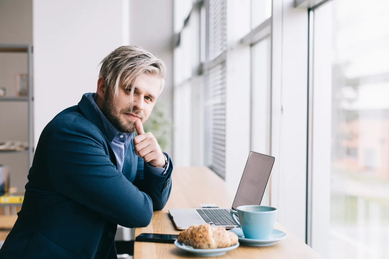 Man working in a cafe on a laptop