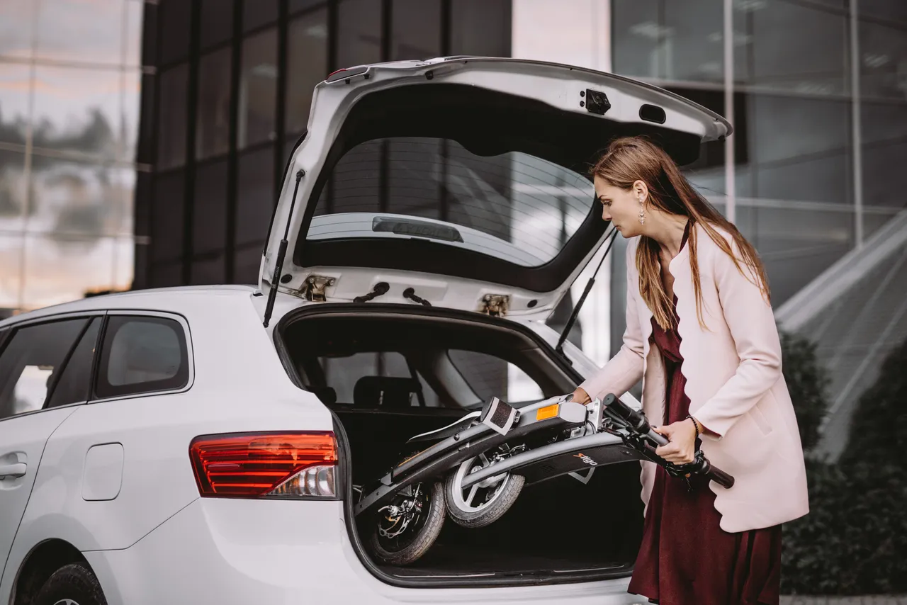 Woman putting electric bike in a car