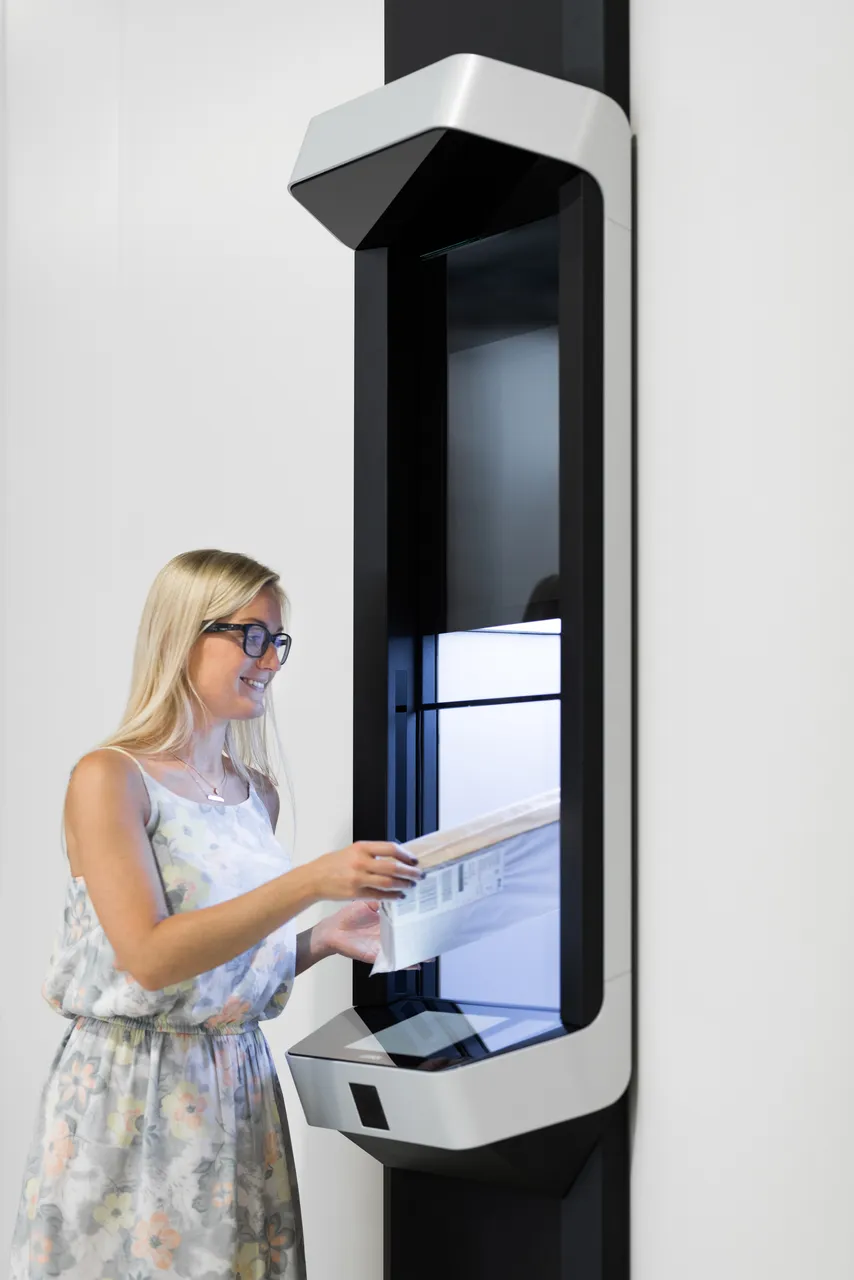 Woman sending package with parcel delivering machine