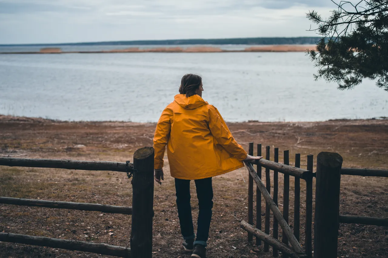Seaside and man in a yellow hoodie