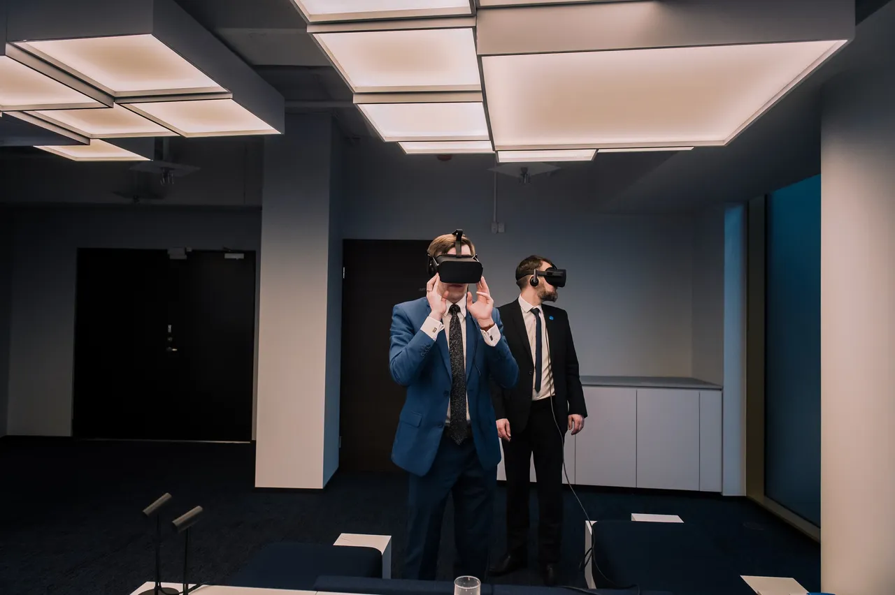 Two men wearing VR glasses