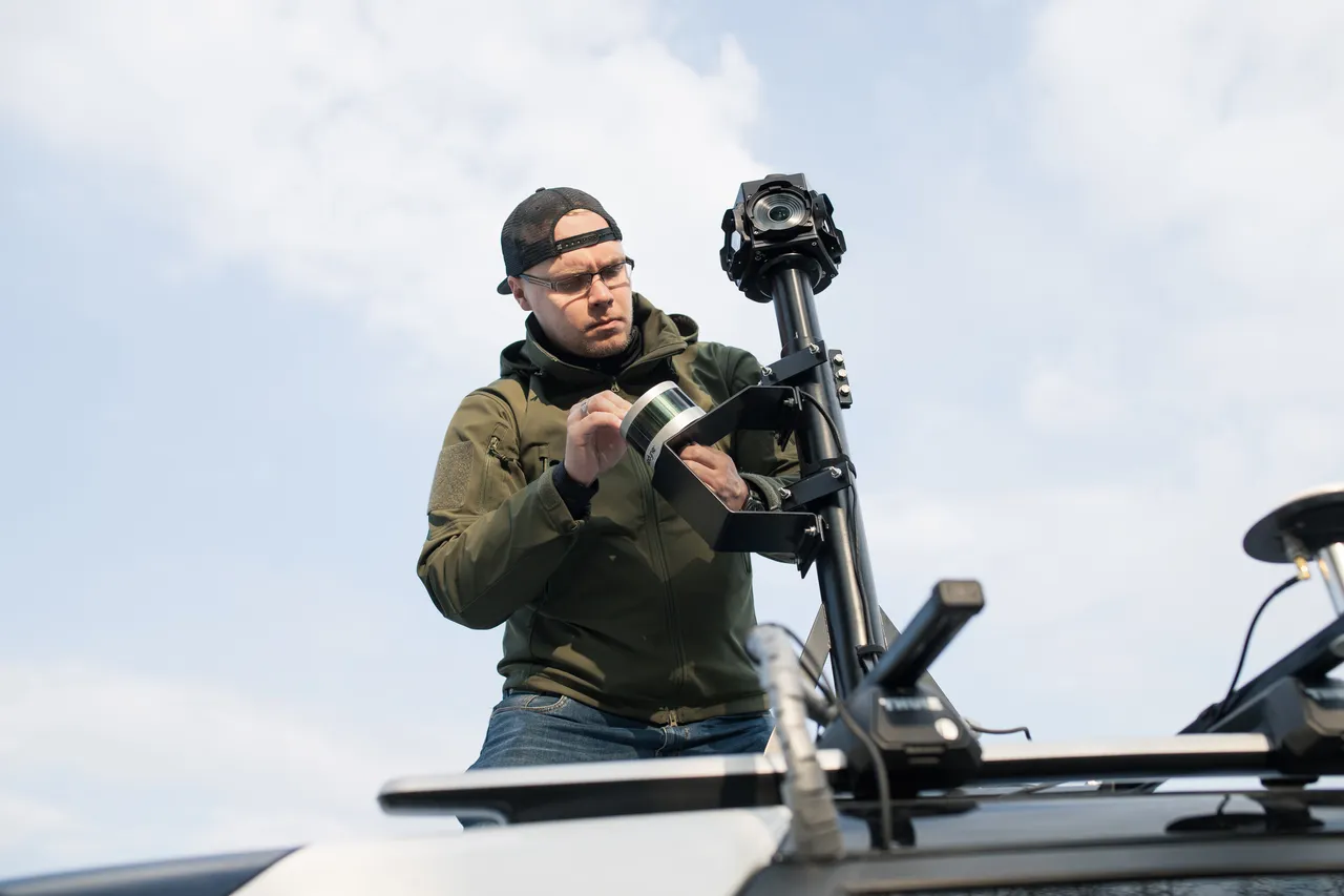Man cleaning data collecting camera