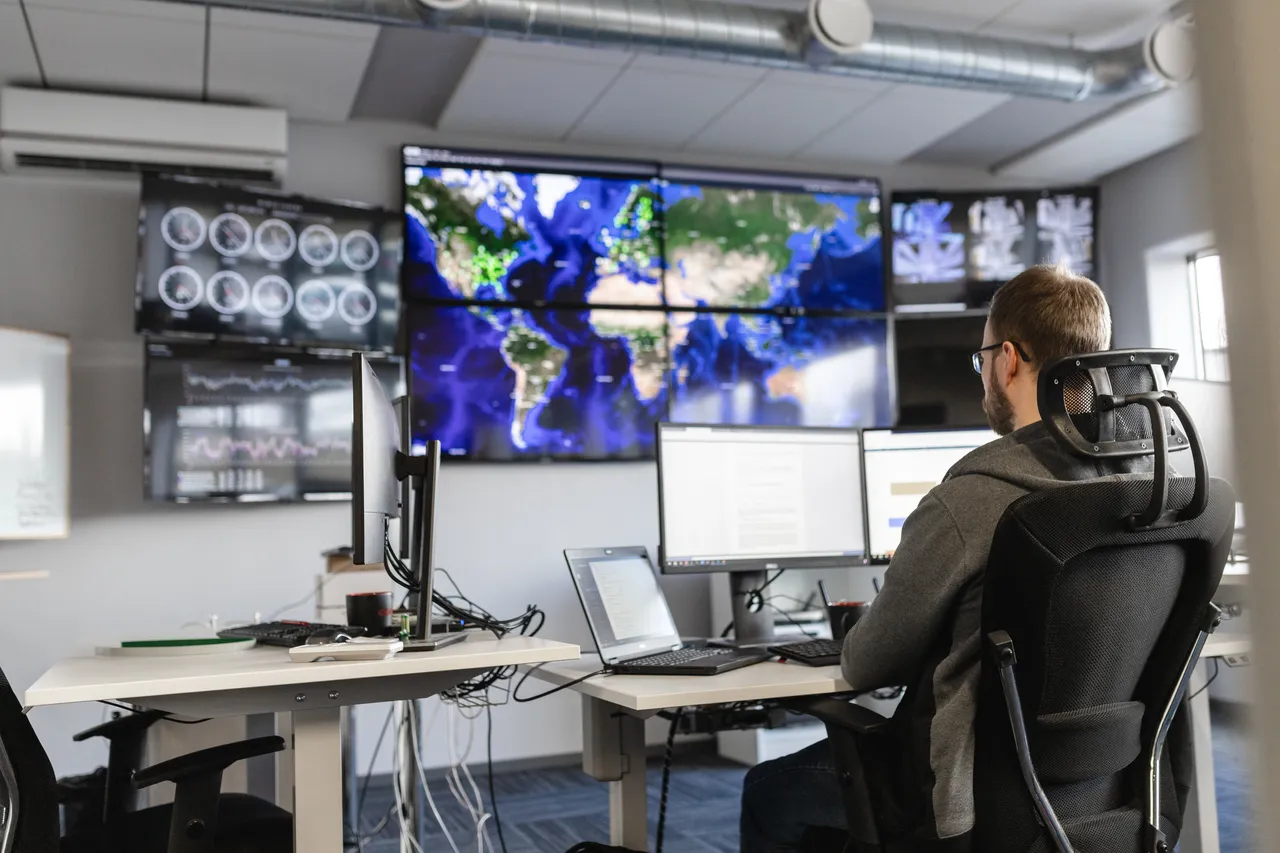 Man working behind screen
