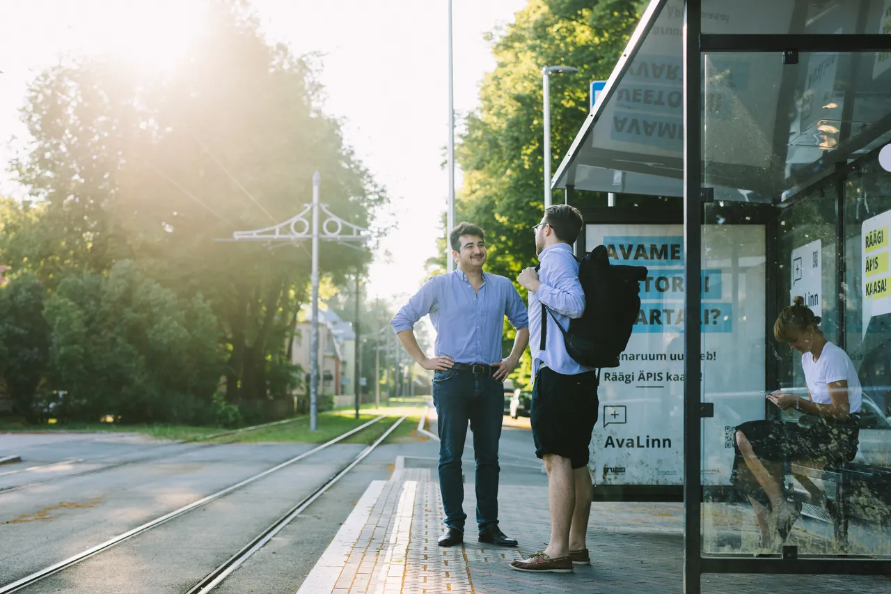 Men waiting tram