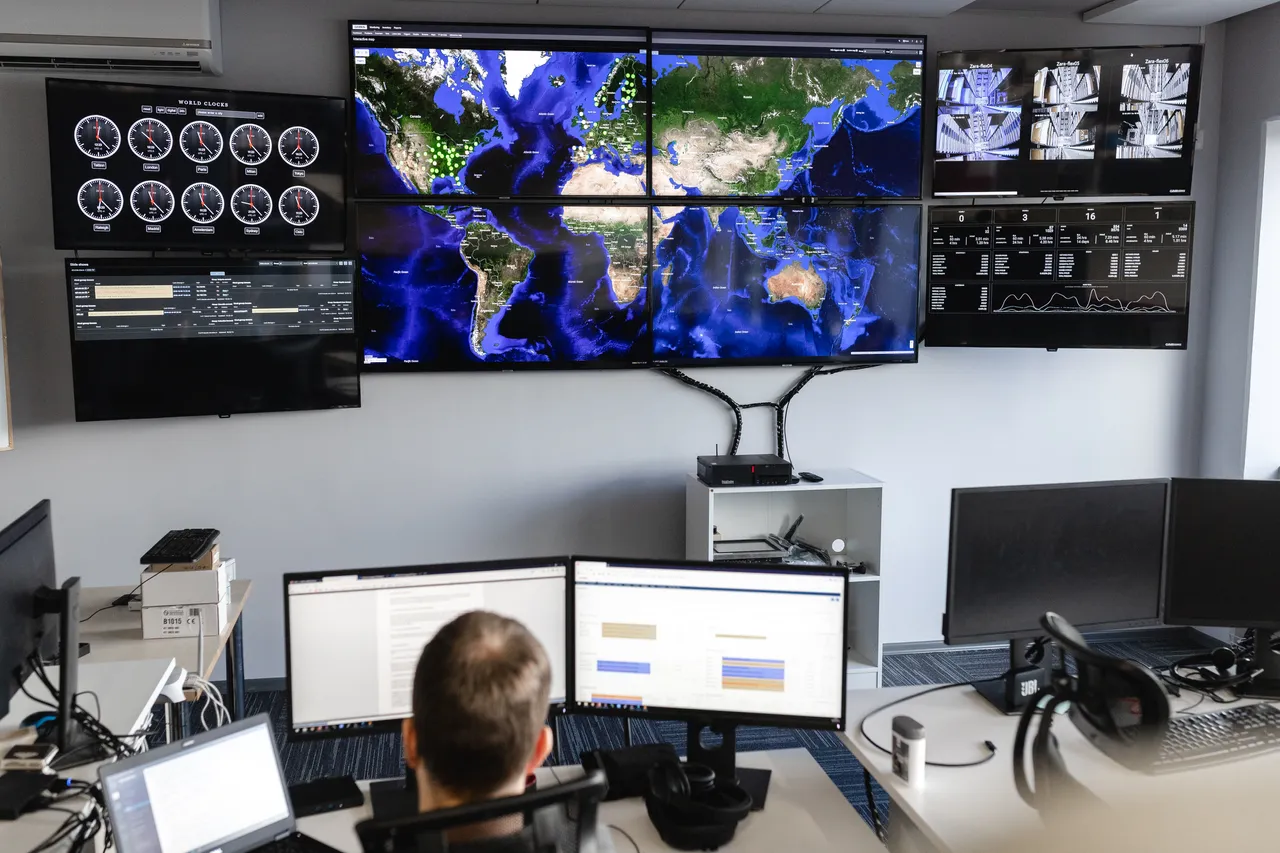 Man working behind large screen