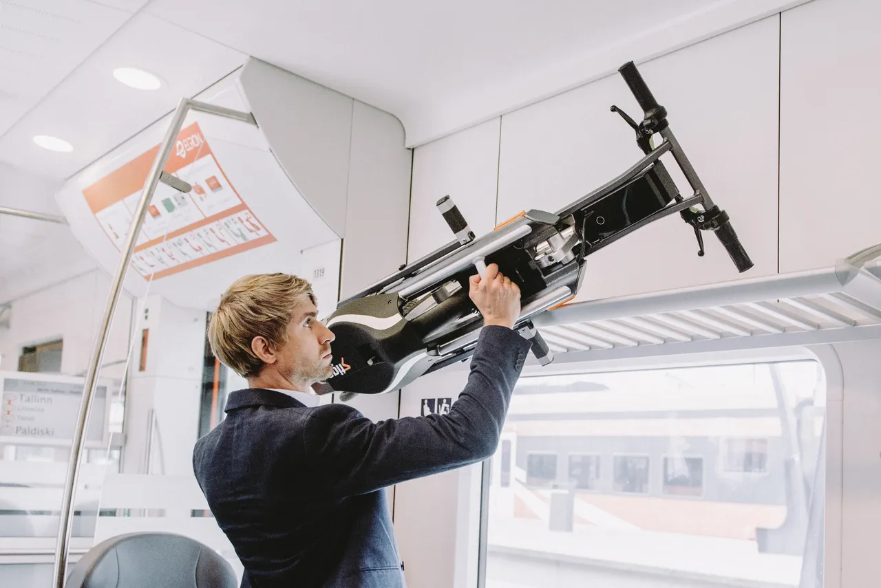 Man putting foldable bike on a train
