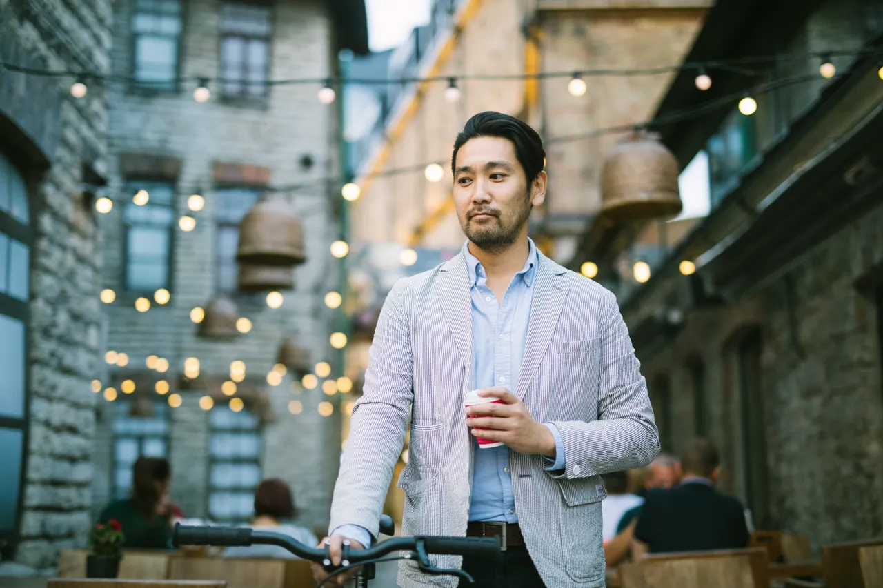 Man drinking coffee in Rotermanni with bike