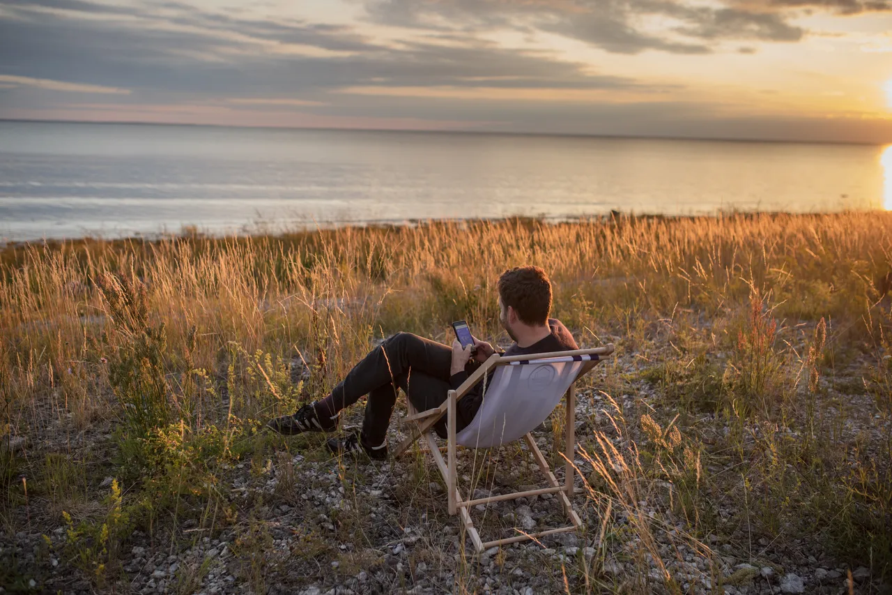 Man at the seaside using mobile phone