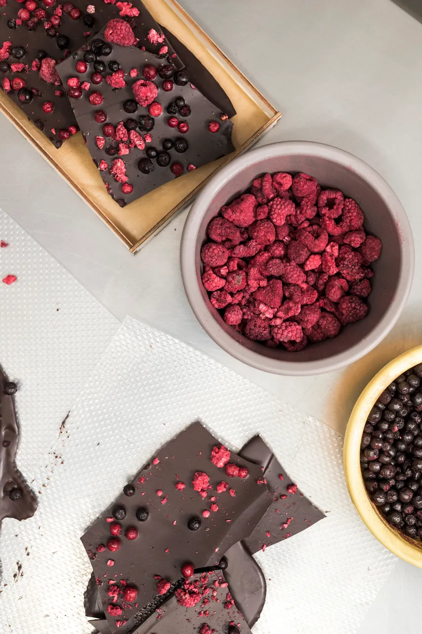 Making handmade chocolate candy with raspberries