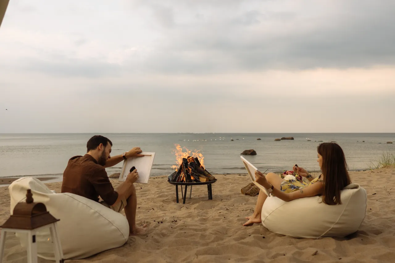 Couple drawing on beach