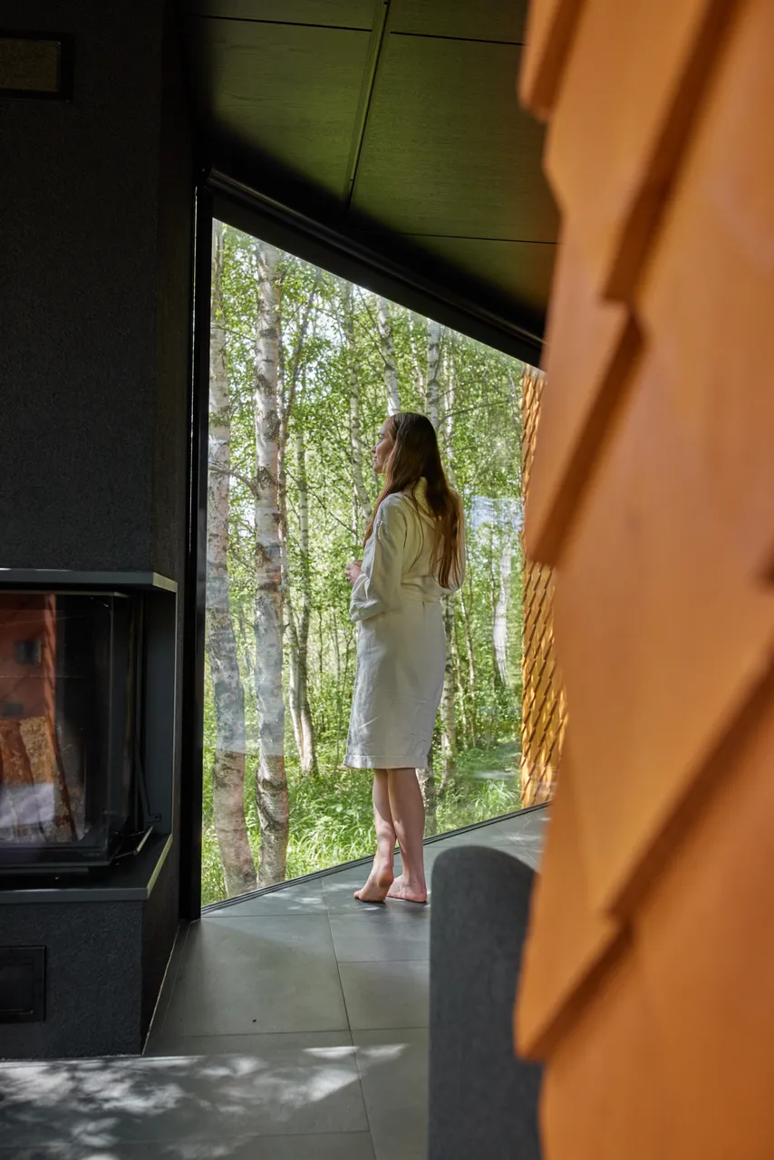 Woman enjoying nature view from window