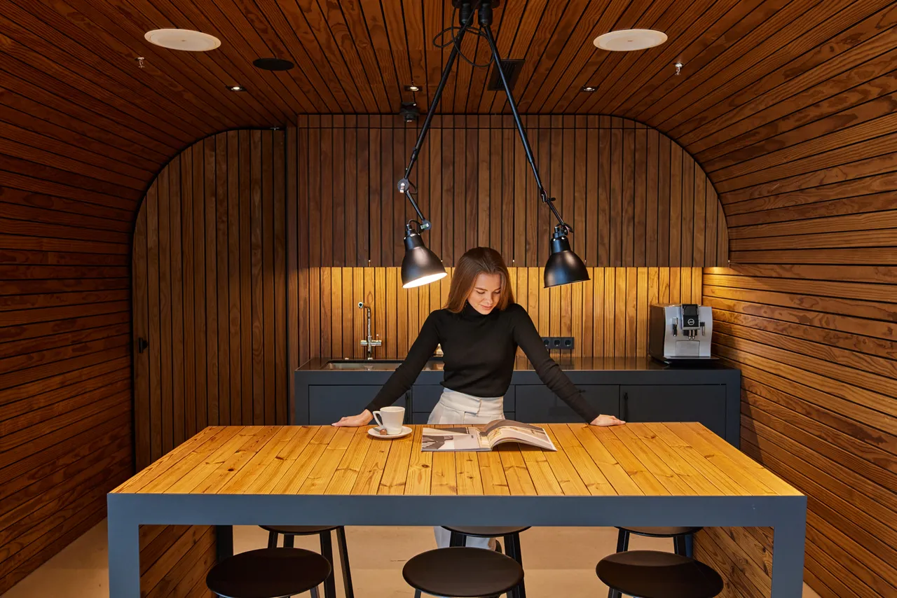 Woman reading in modern wooden kitchen