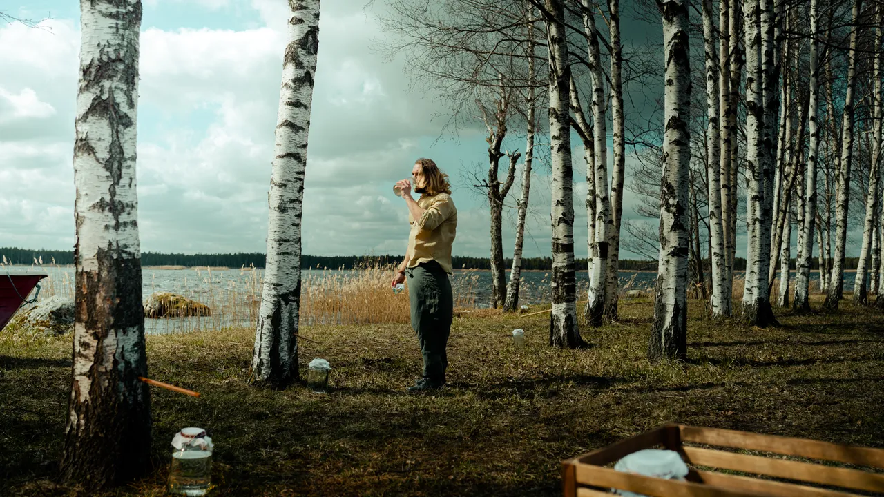 Man drinking birch sap