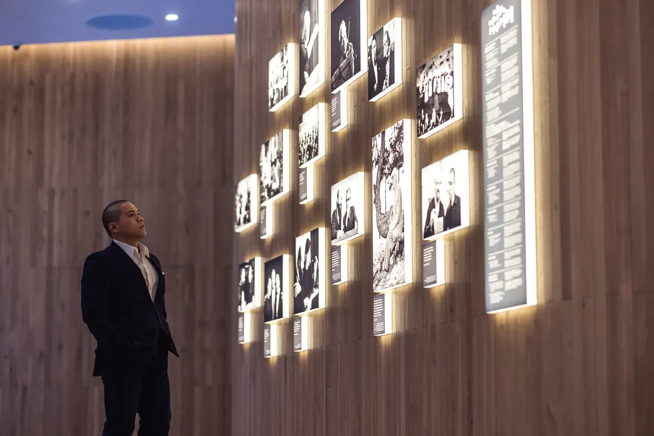Man reading biographical wall display