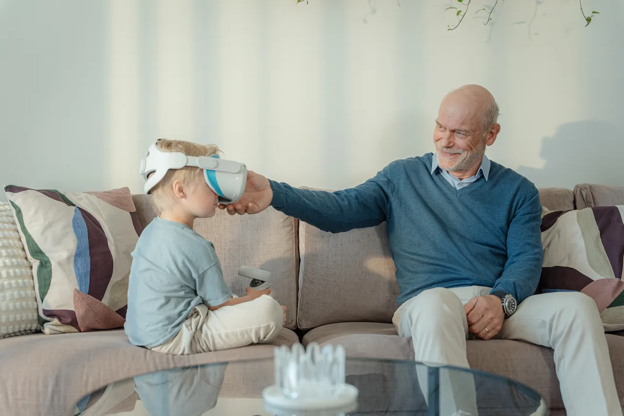 Grandfather helping with VR headset