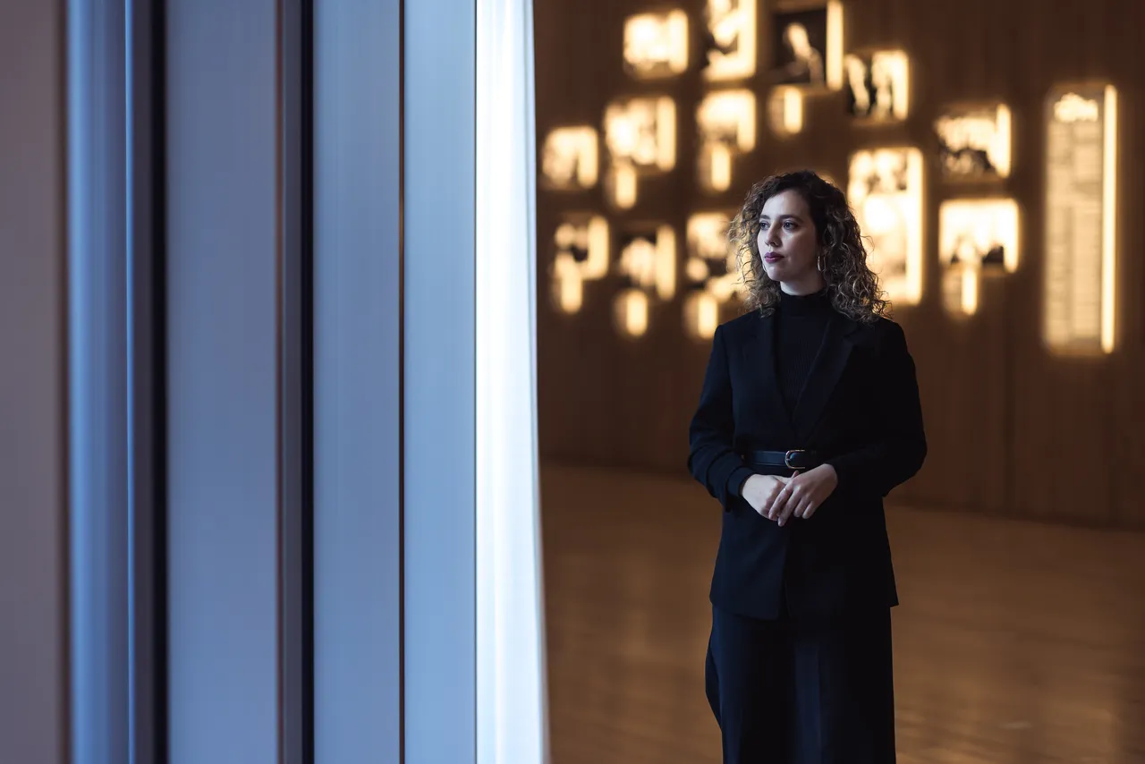 Woman standing by the window in wooden interior