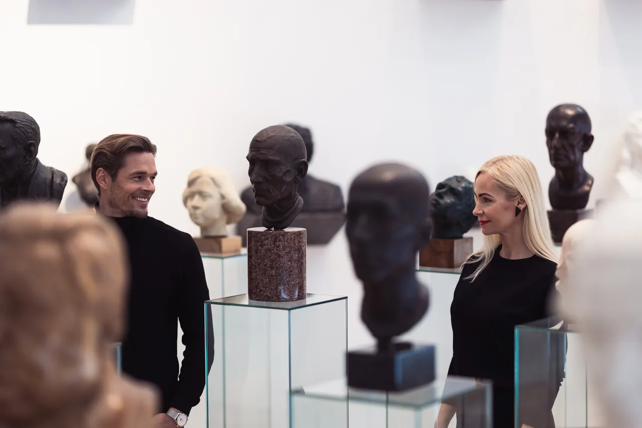 Couple viewing sculptures in museum