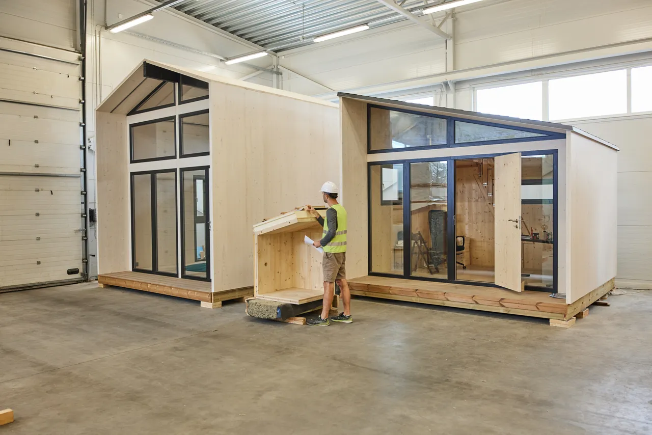 Worker inspecting wooden house structure