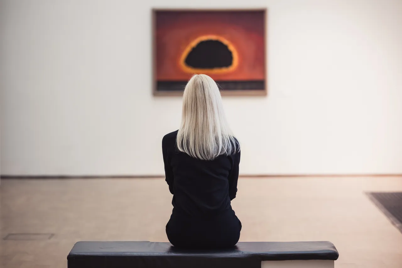 Woman looking at painting