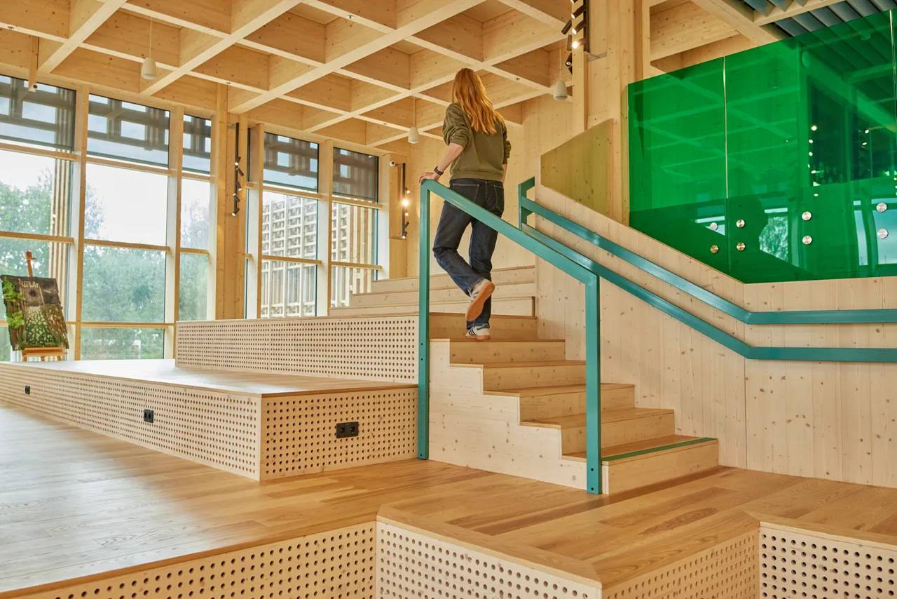 Student walking up stairs in open learning space