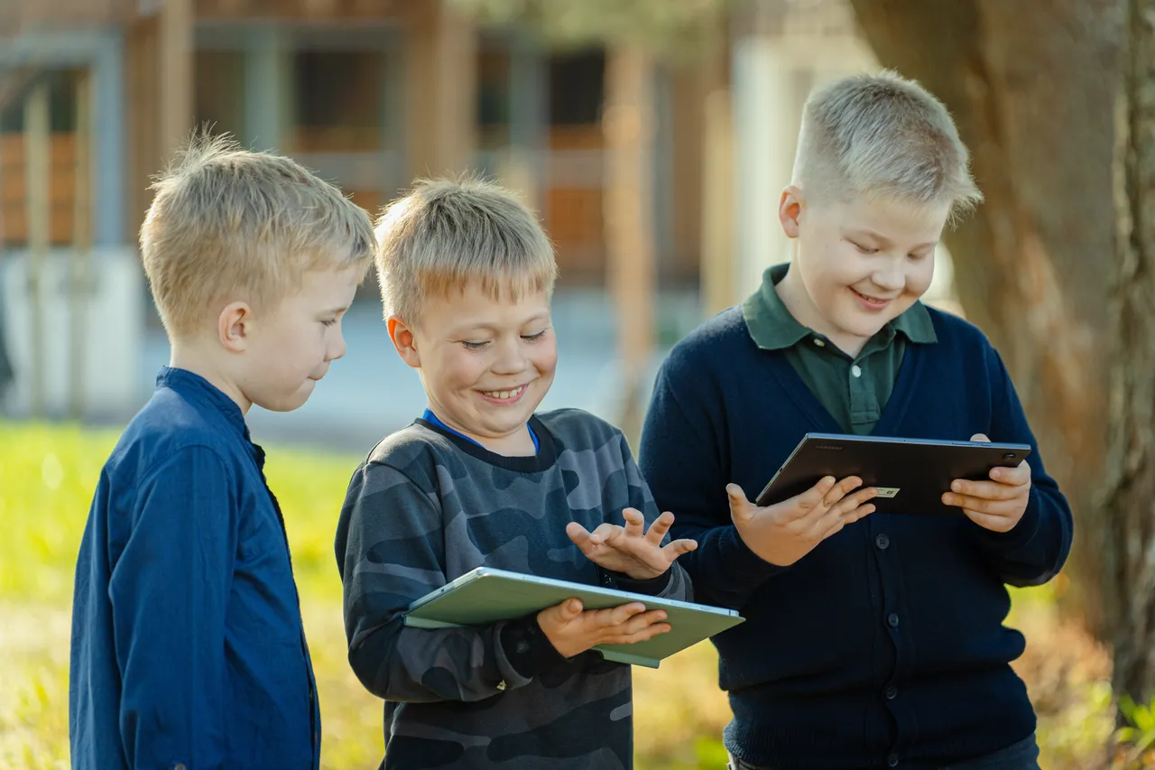 Children using tablets outdoors