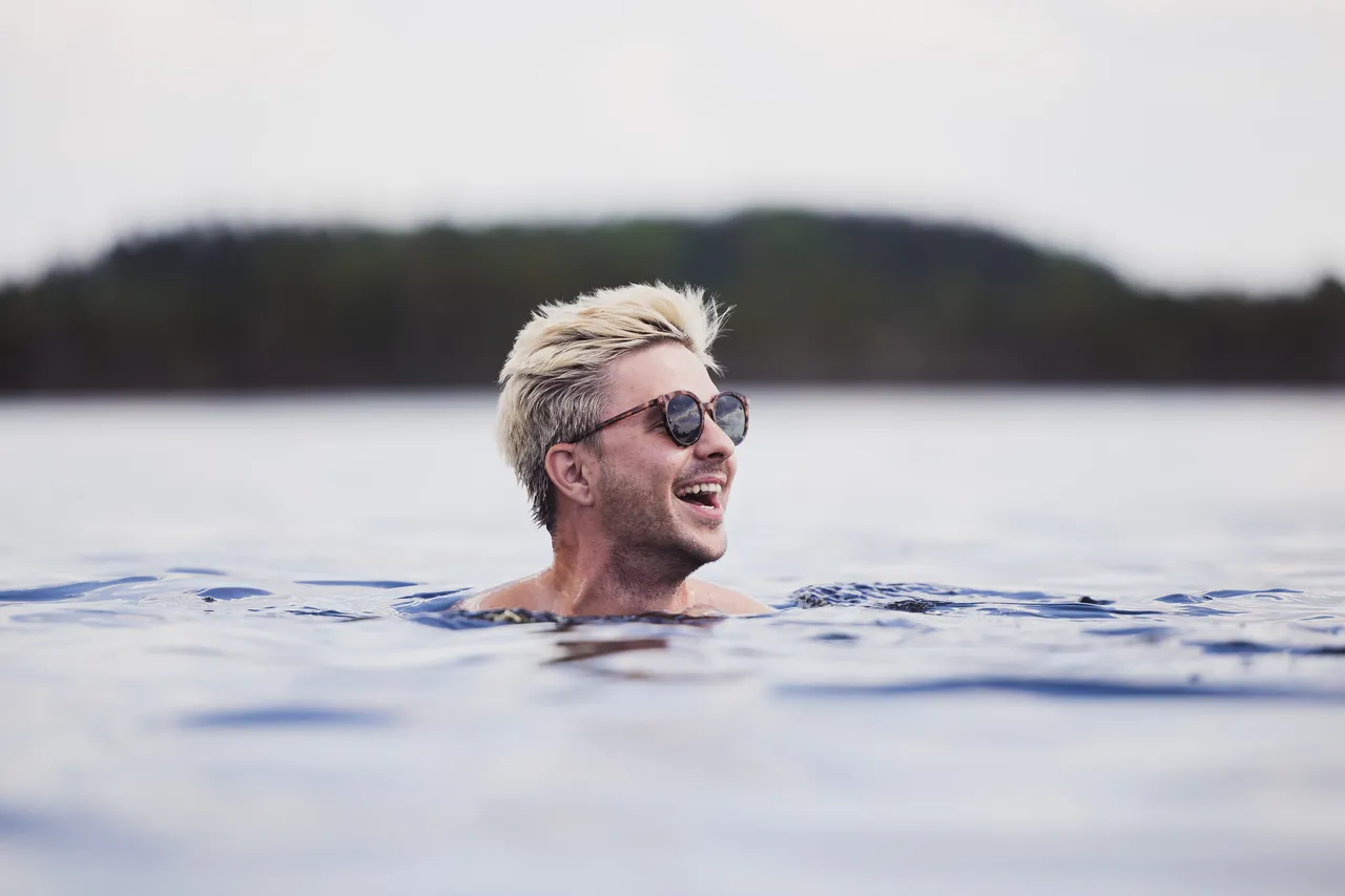 Man swimming in bog lake