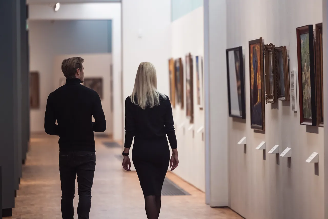 Couple walking through exhibition hall