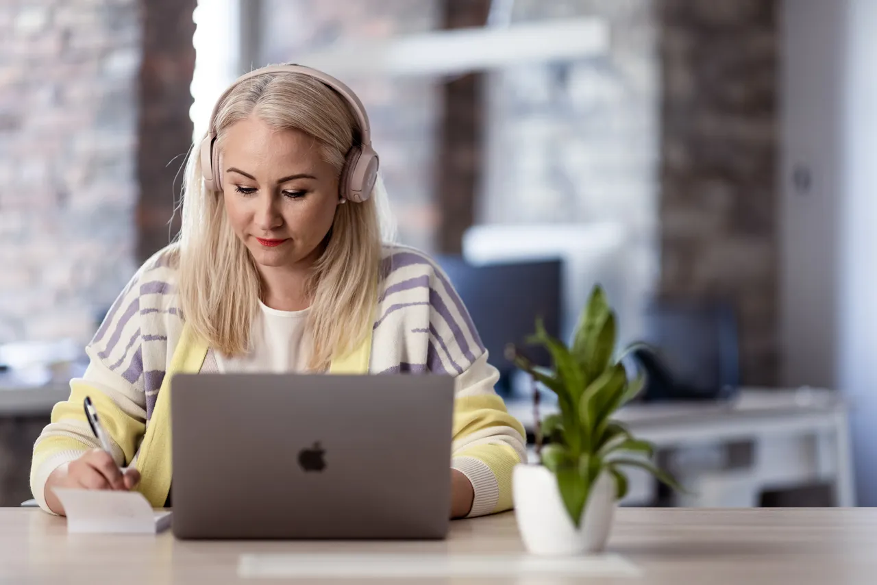 Woman studying with headphones
