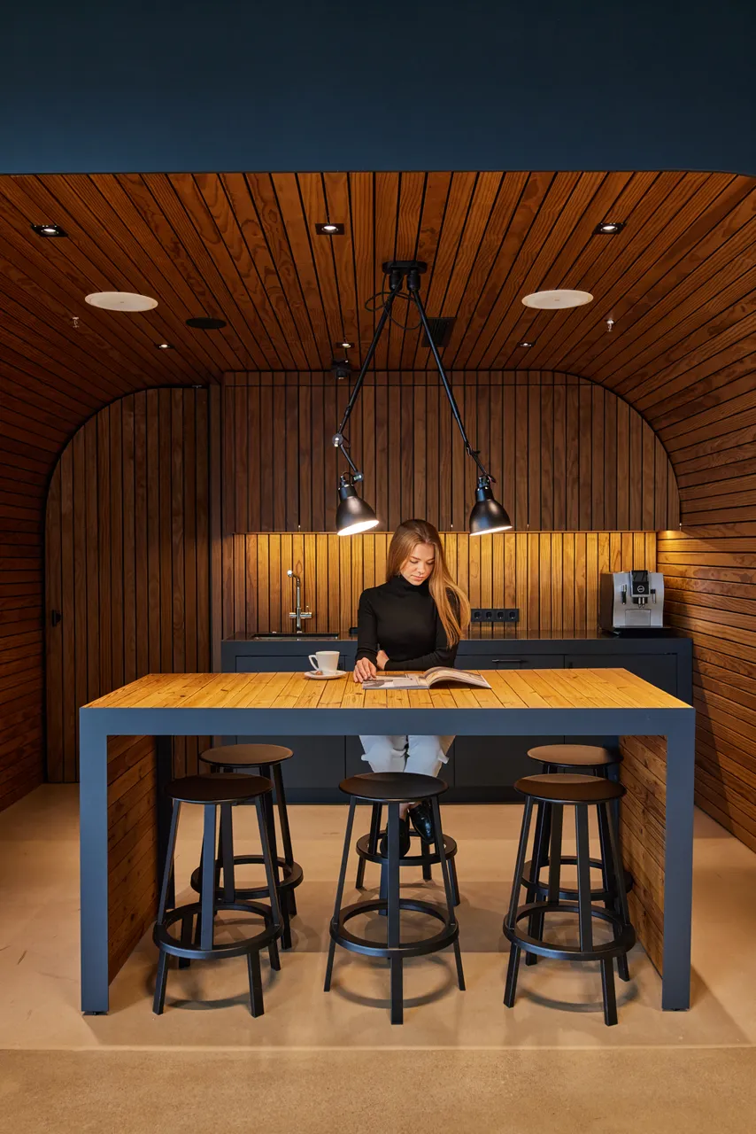 Woman reading in modern wooden kitchen
