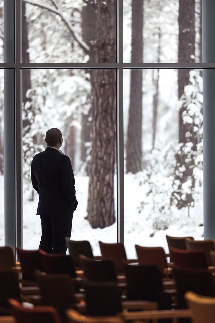  Man looking out at snowy forest
