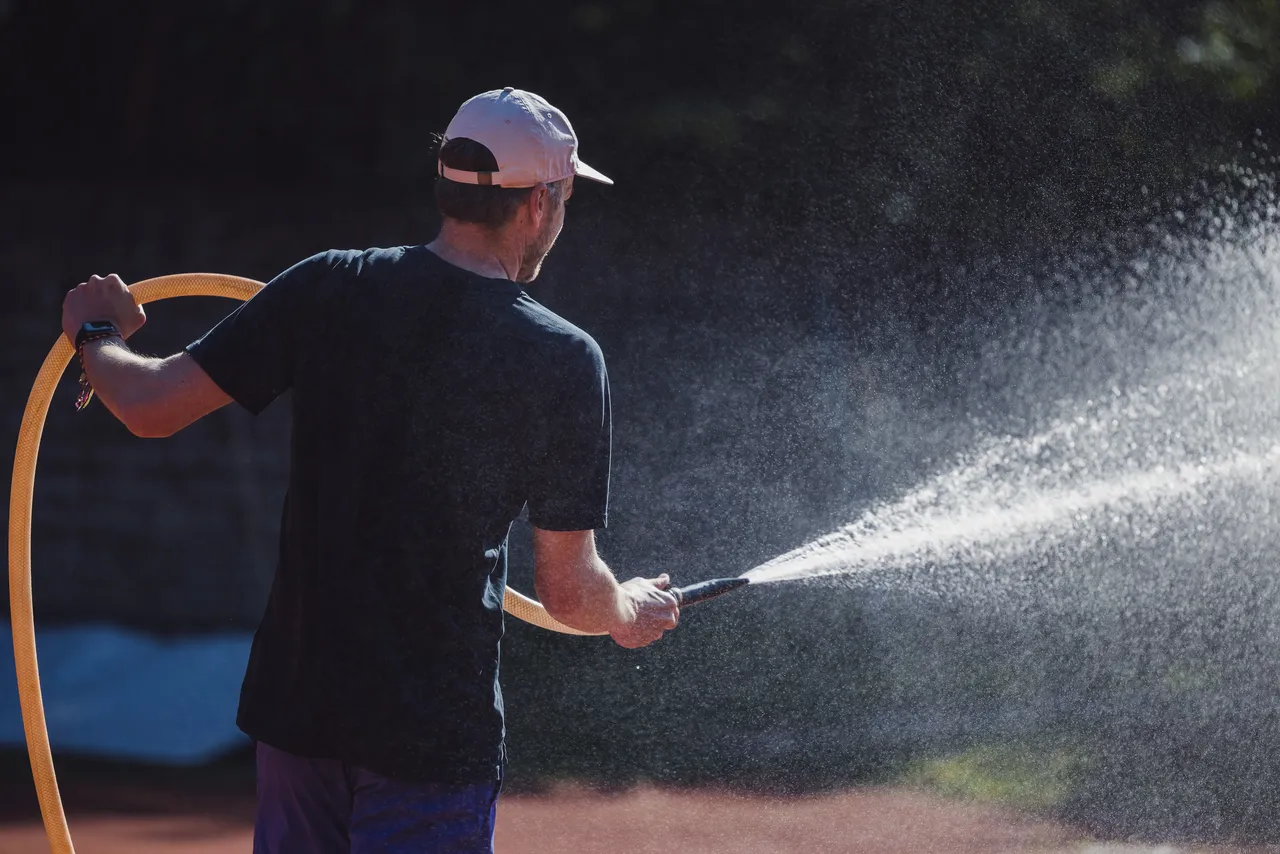 Man watering with hose