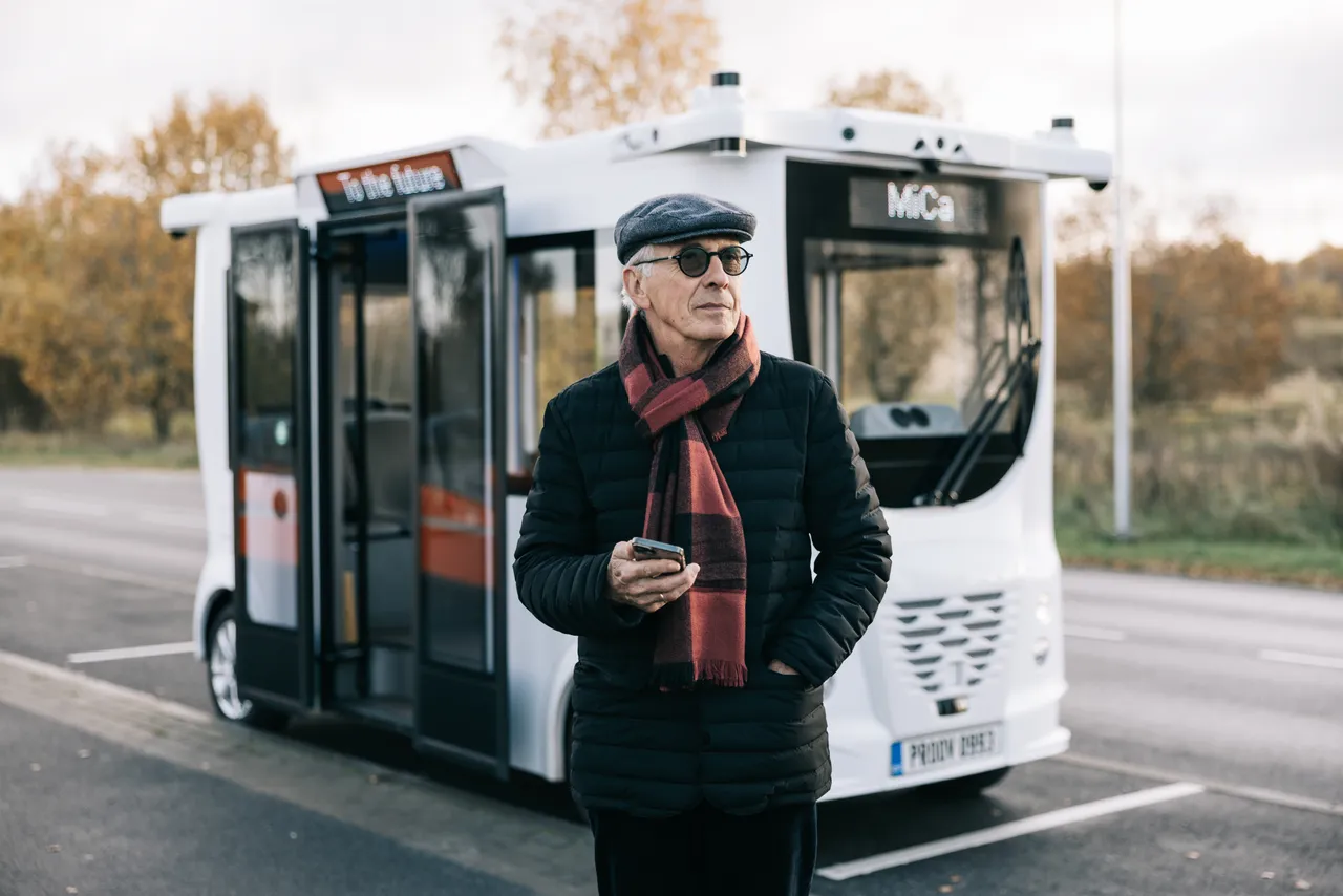 Man standing in front of self-driving bus