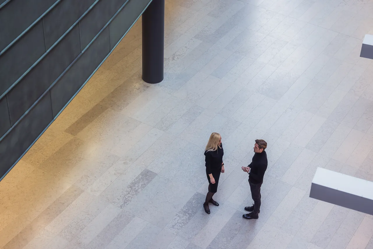 Couple talking in public building