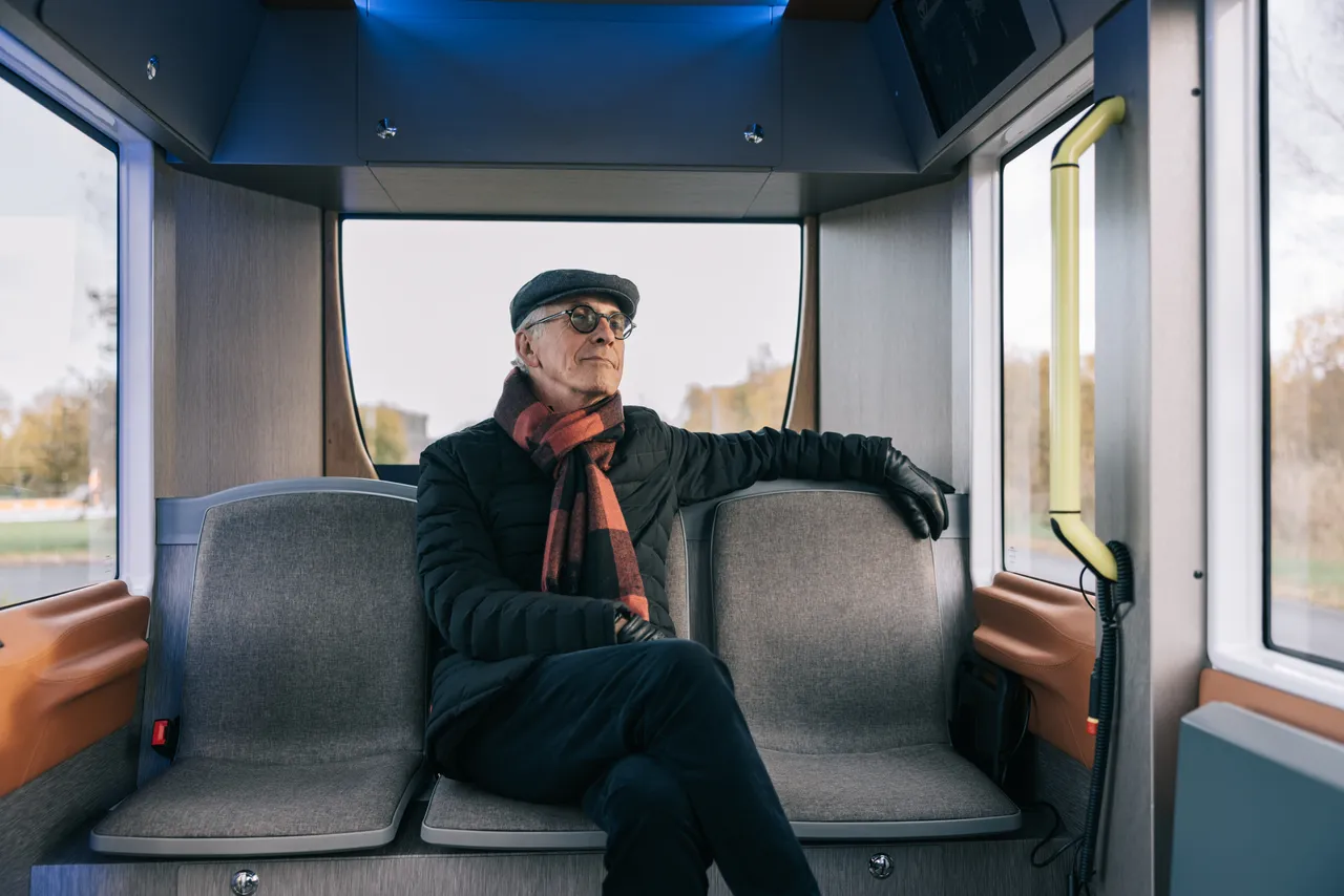 Man sitting in a self-driving bus